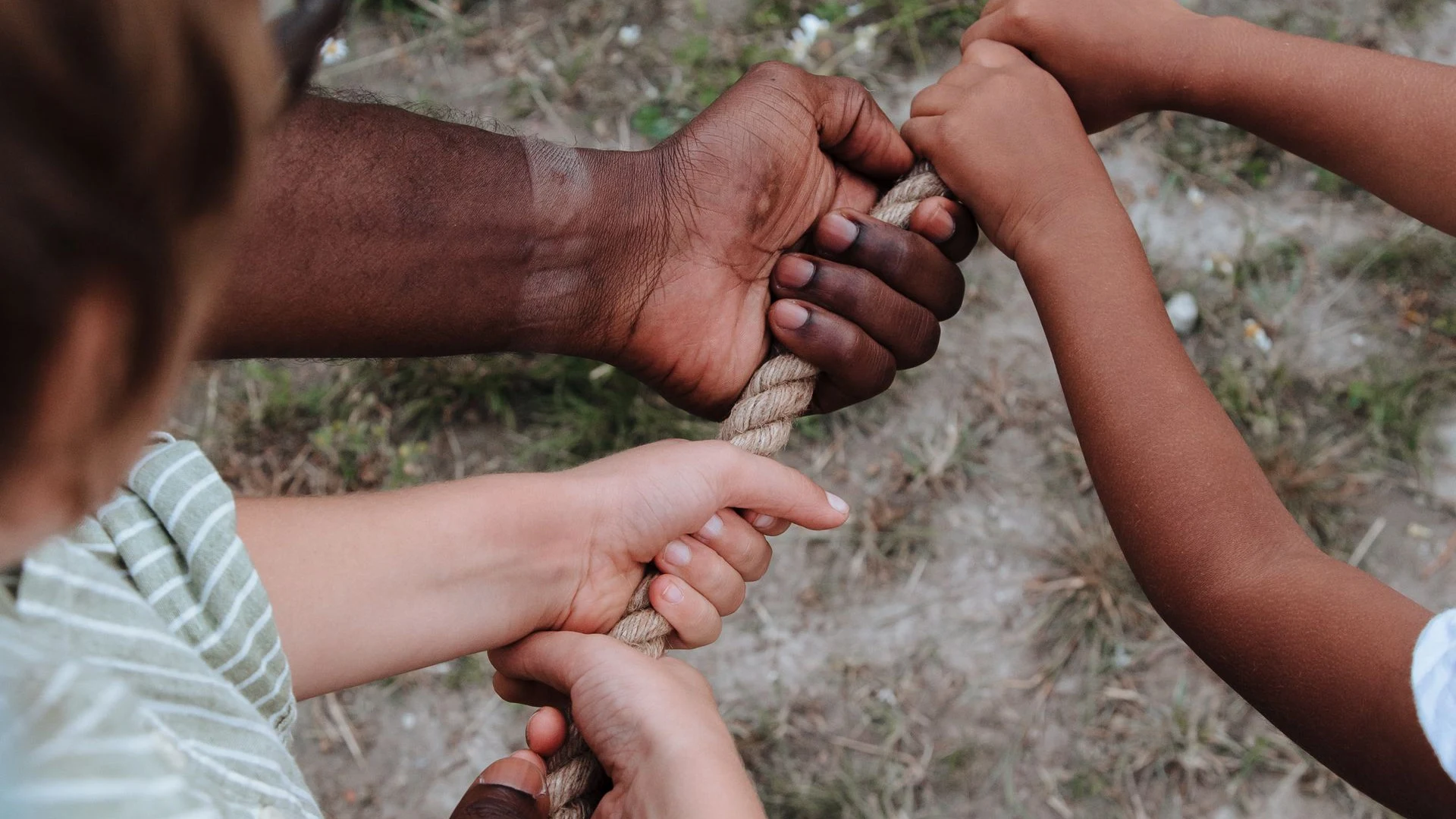 Hands gripping a tug-of-war rope