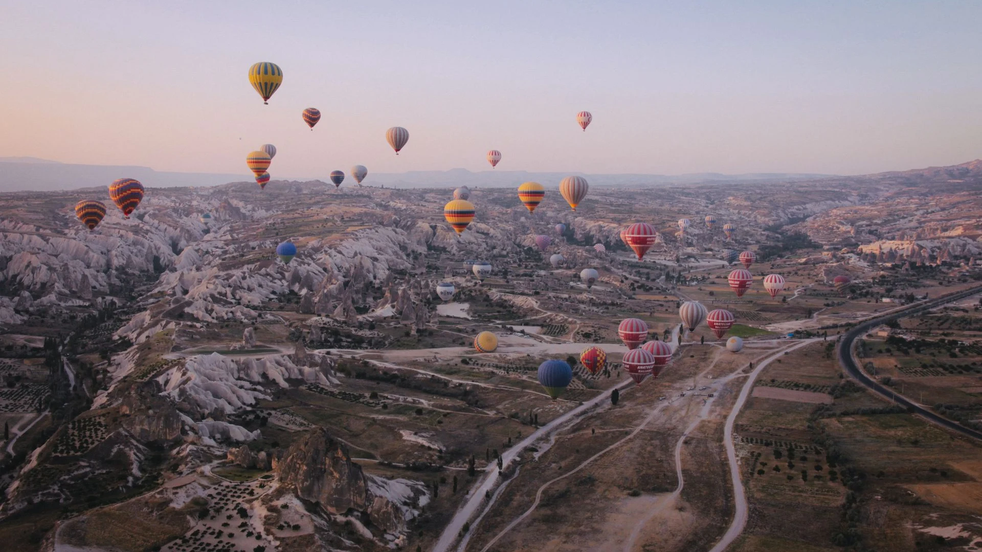 Dozens of hot air balloons filling sky