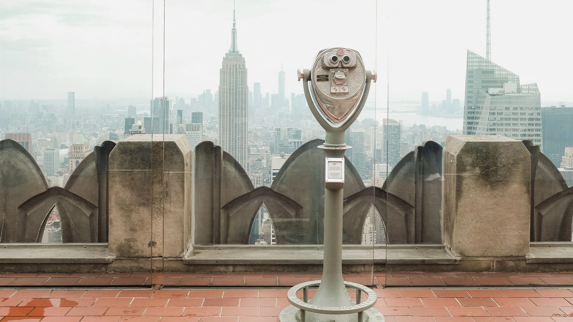Coin-operated viewer overlooking a city