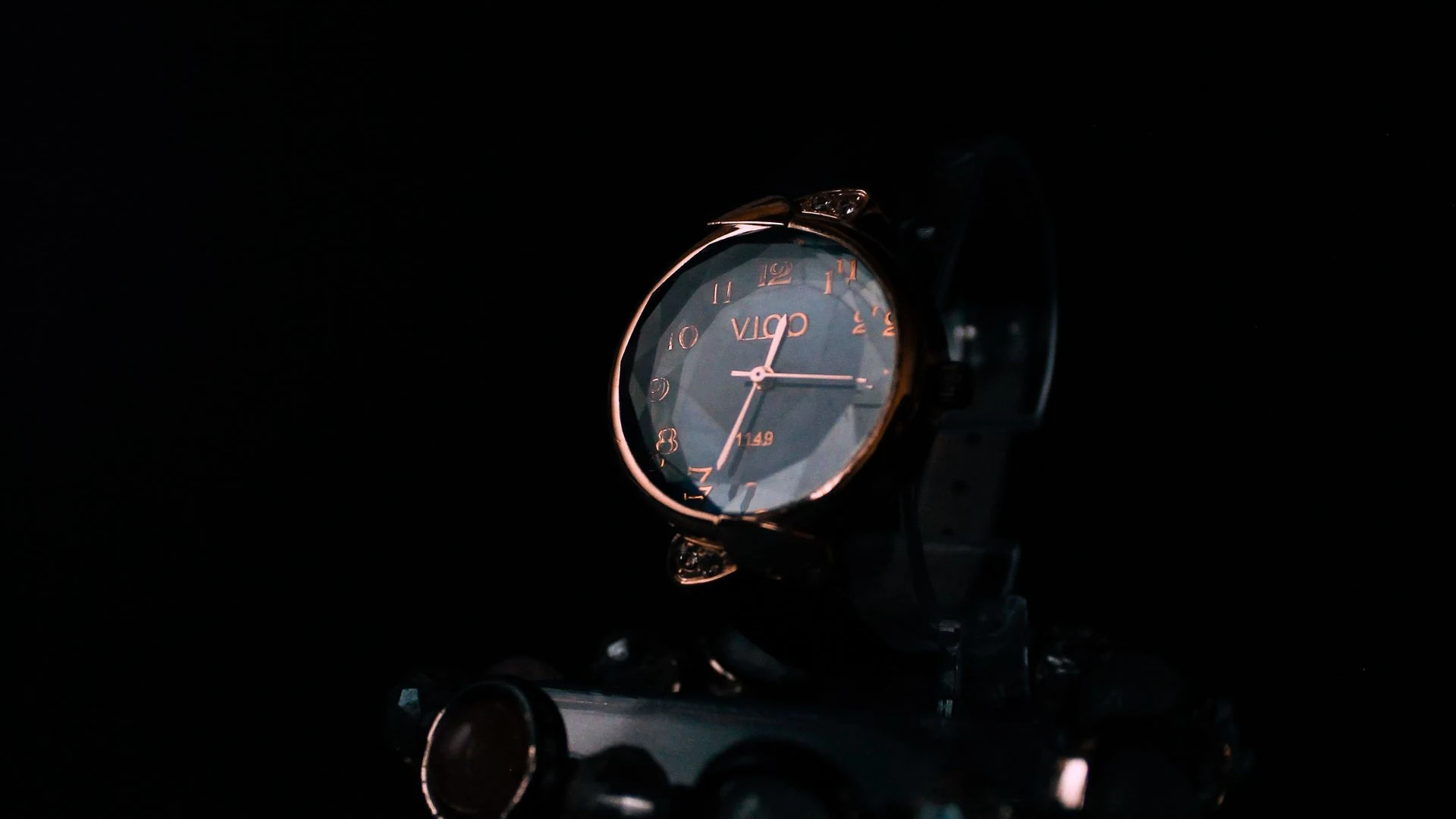 Luxury wristwatch emerging from darkness