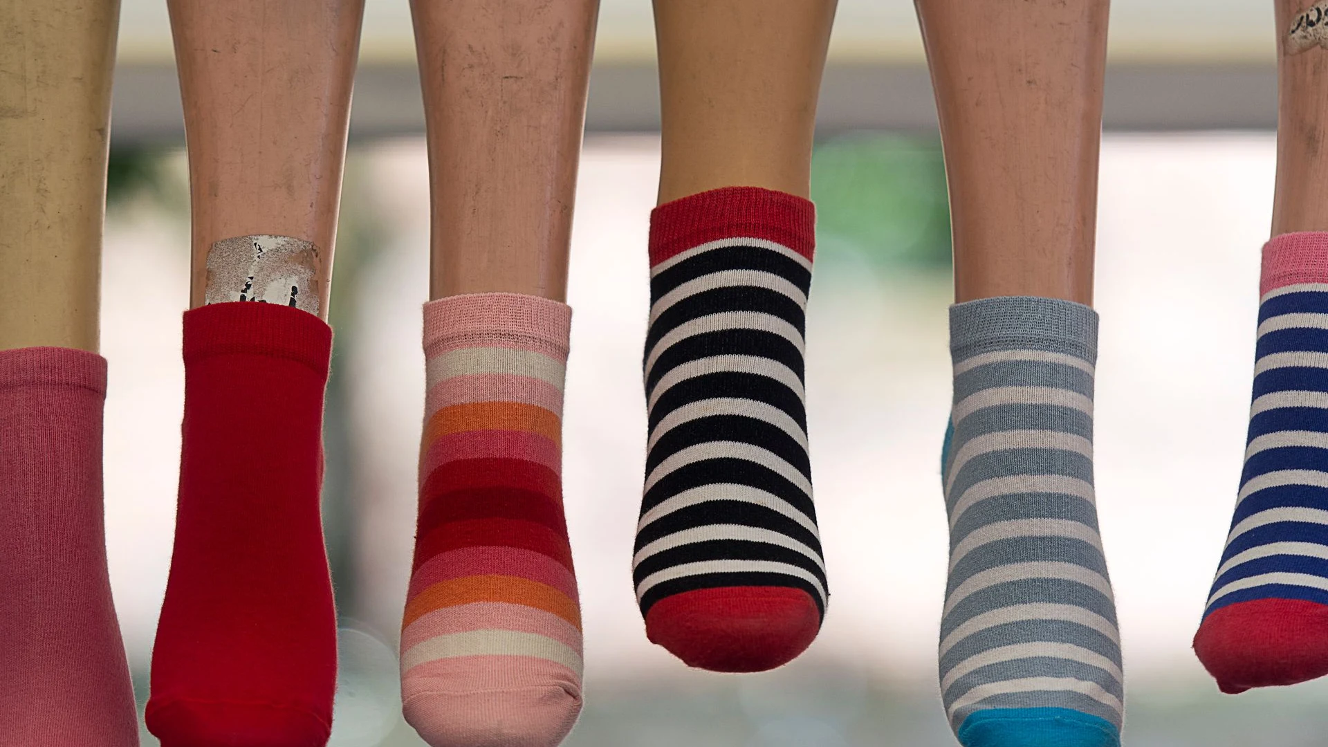 Two pairs of feet in mismatched socks