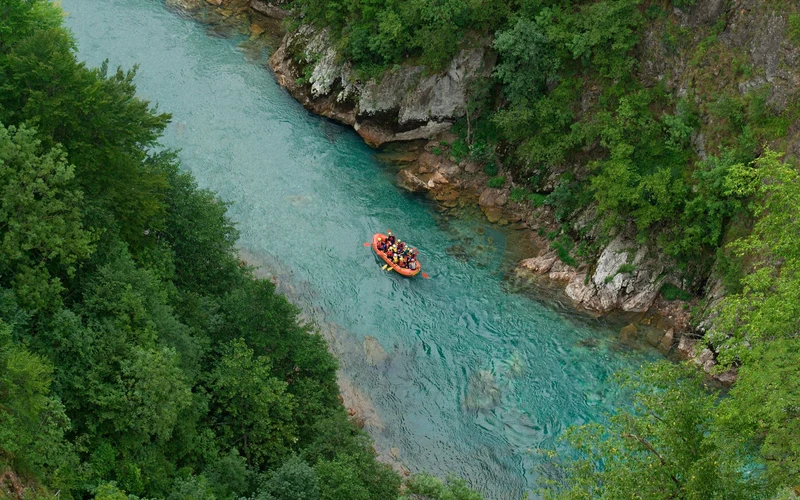 Aerial raft crew paddling in unison