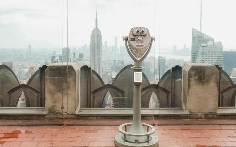 Coin-operated viewer overlooking a city