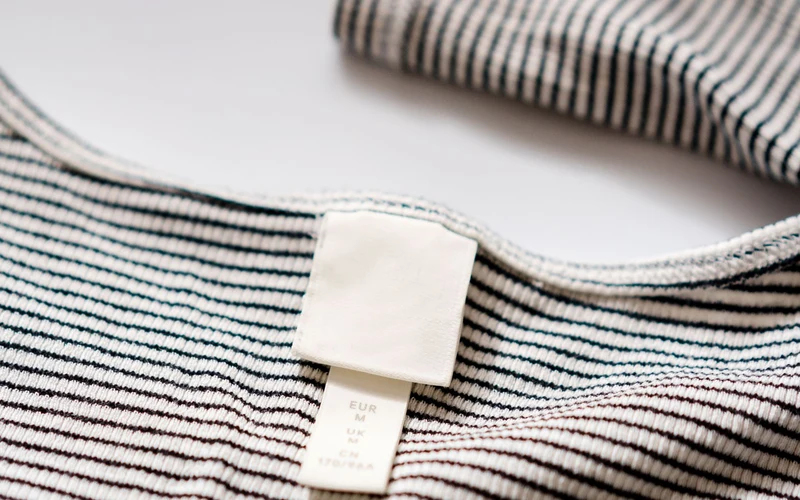 Woven clothing label on striped garment