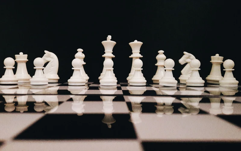 White chess pieces arranged on a board