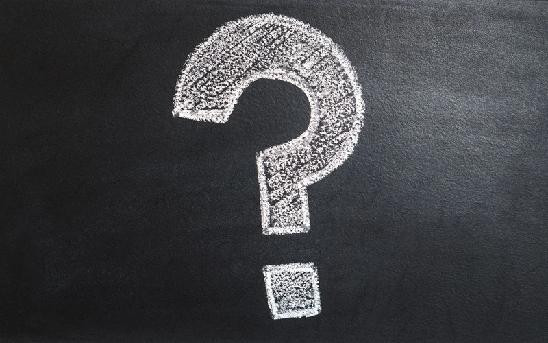Chalk question mark on blackboard