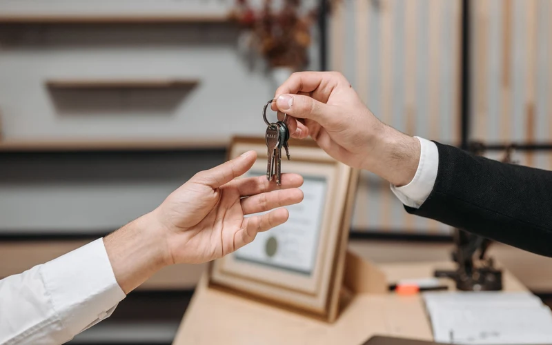 One hand passing keys to another