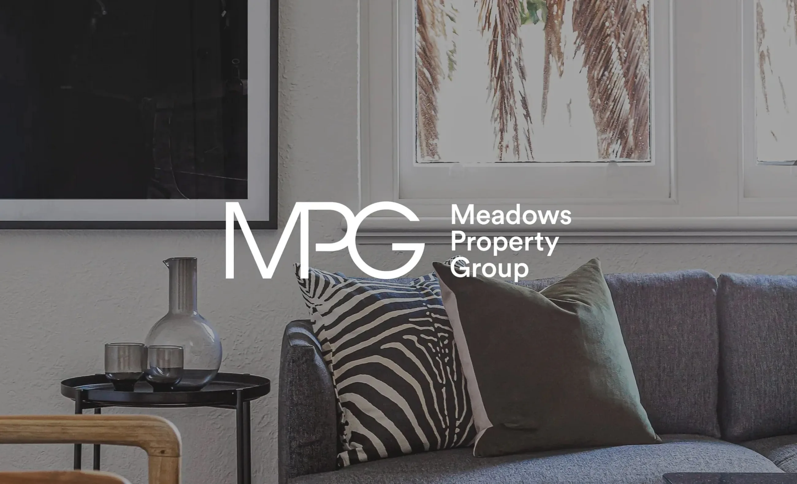 Meadows Property Group framed logo in a styled interior