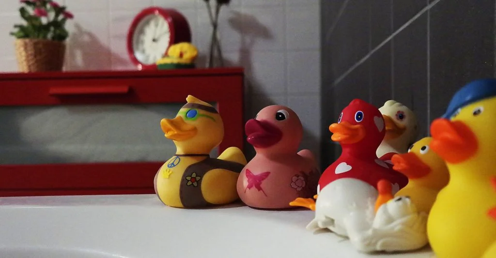 Rubber Ducks on Side of Bathtub
