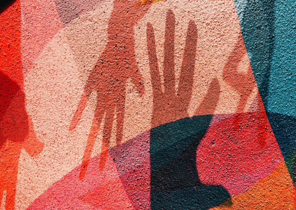 Shadow hands on a bright wall. Your biggest selling tool is your point of difference with other businesses. 