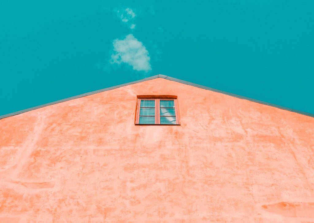 Image of a pink wall with a single window reaching into the sky. Your brand is also your promise to consumers. 
