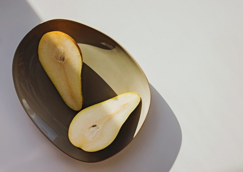 A cut open pear on a rustic style plate. Choosing the right name is essential for any business. 