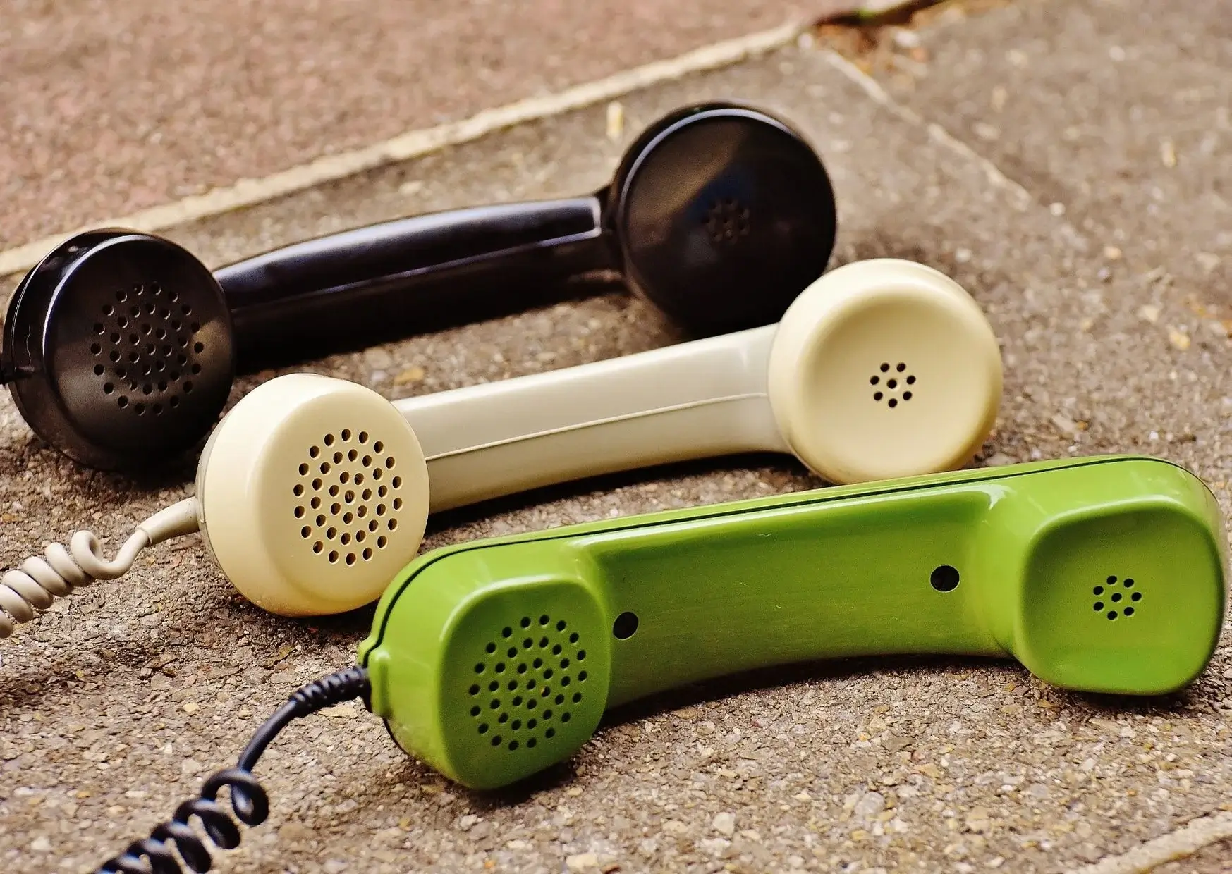 Three Old Telephones on Floor